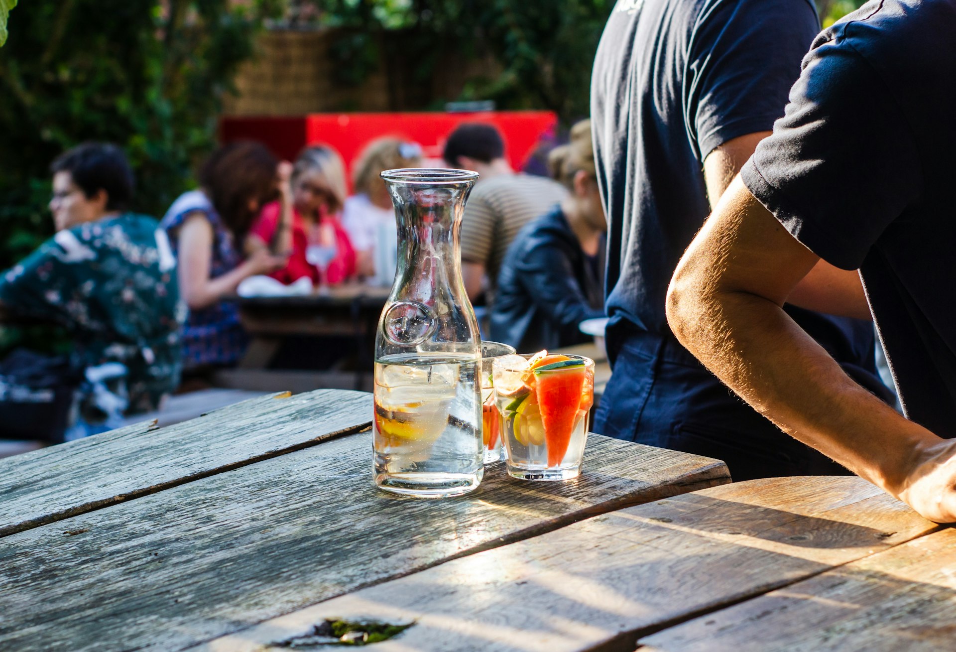 clear glass bottle across people